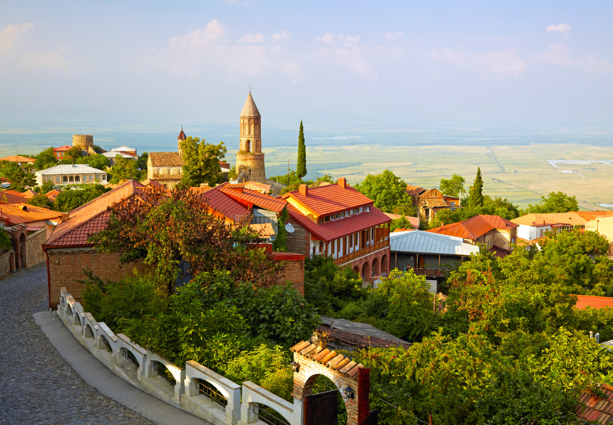 A smal clifftop town with red brick buildings, overlooking the countryside