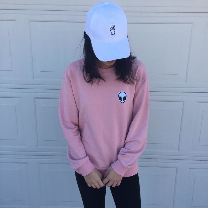 reviewer wearing the pink one with an alien patch in corner 