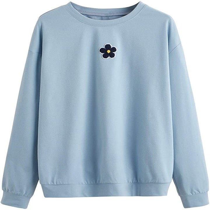 the blue sweater with flower patch in top center  