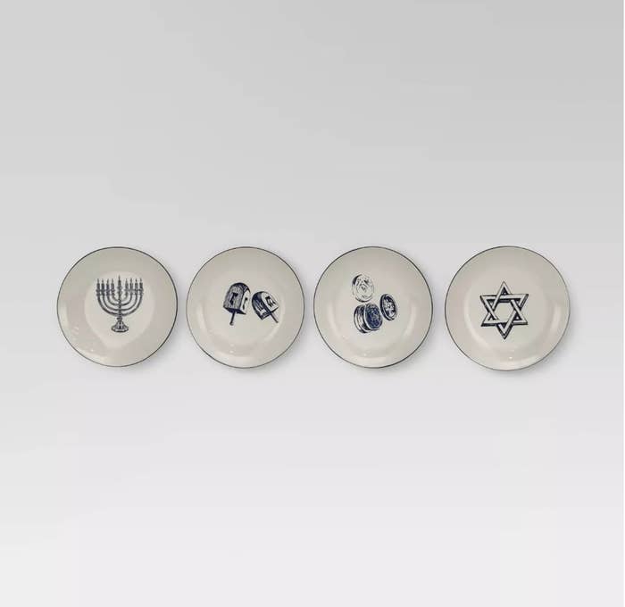 Four ceramic plates with menorah, dreidels, gelt and star of Davi