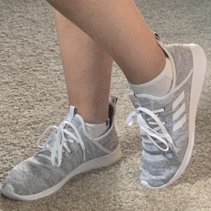 Reviewer wearing gray sneakers