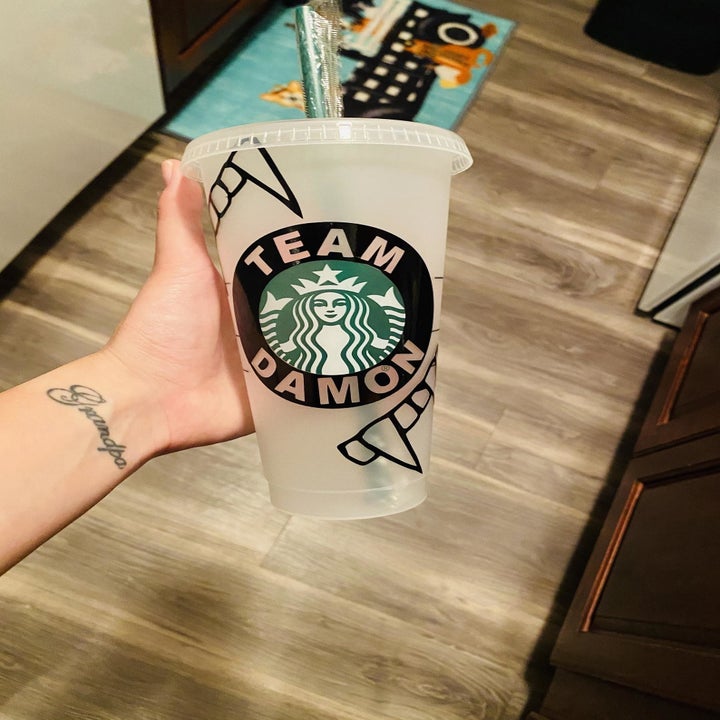 the clear cup with label that read "Team Damon" 