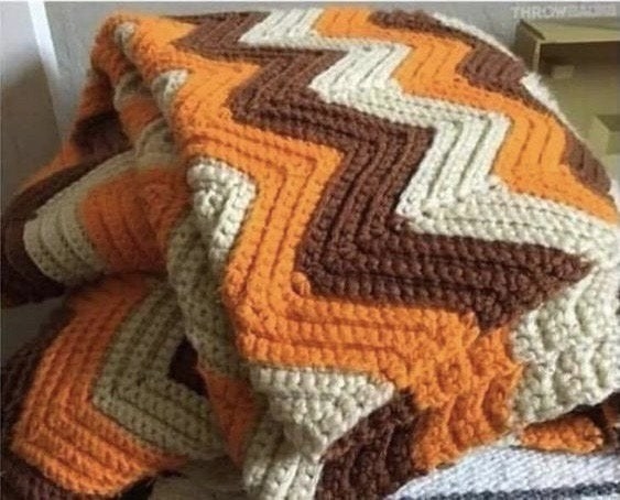 A crocheted blanket with a zigzag pattern