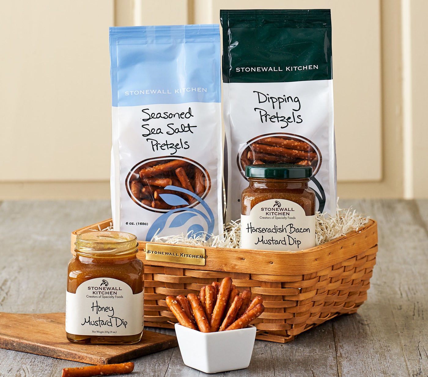 basket with two bags of pretzels and two mustard dips
