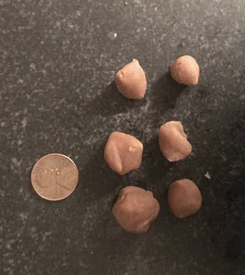 Reviewer photo of the pills covered in the pill pocket next to a penny for size reference