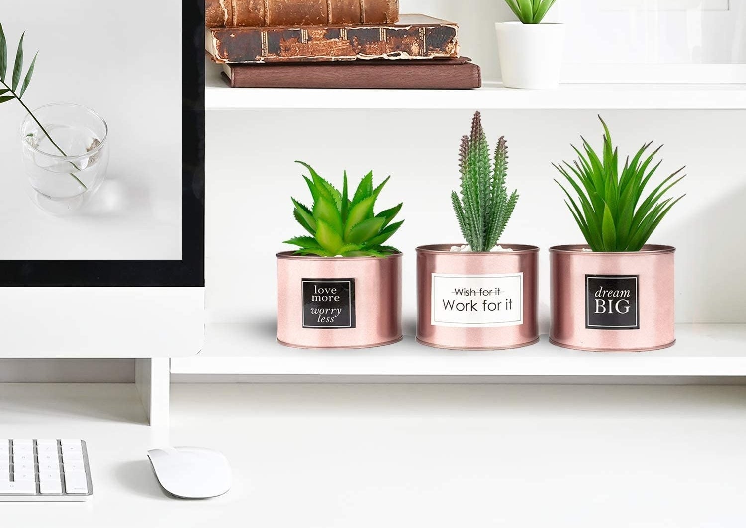 Desk with three rose gold mini planters with artificial succulents placed inside