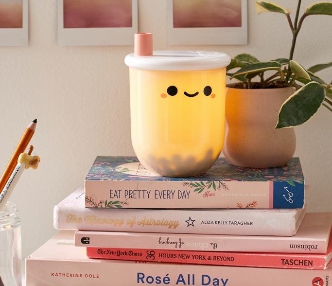 Mini boba tea-shaped lamp placed on a stack of books