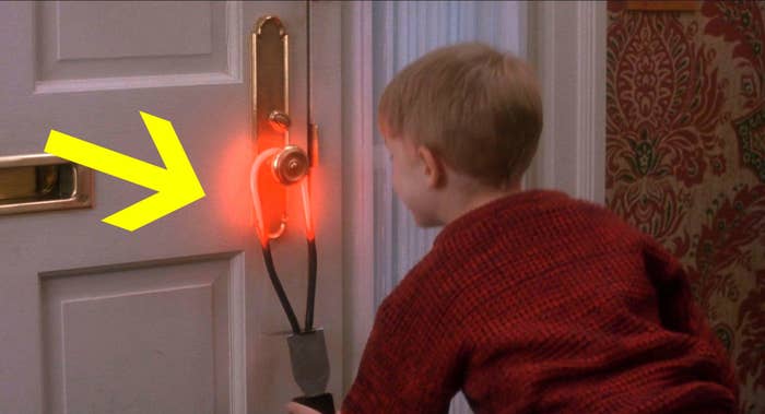 Kevin from Home Alone hanging a hot ring on the front door handle