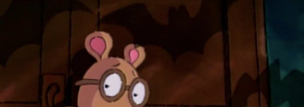 Arthur looking scared in dark library surrounded by bat like shadows
