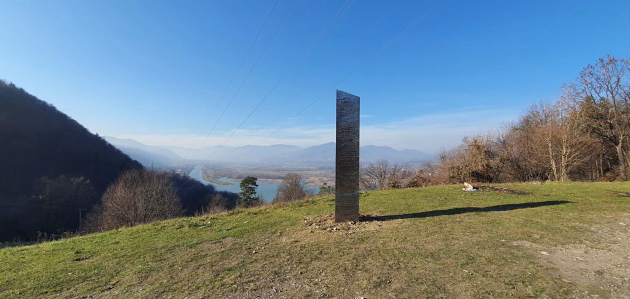 A chrome monolith on top of a hill