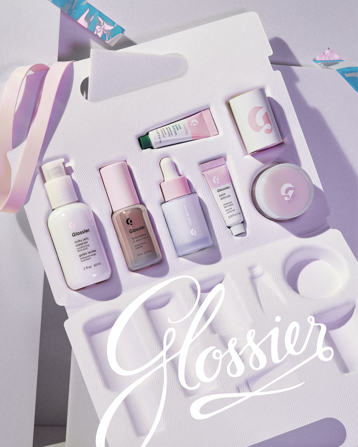 The Skincare Edit set in a recyclable molded paper case filled with mini Glossier skincare bestsellers
