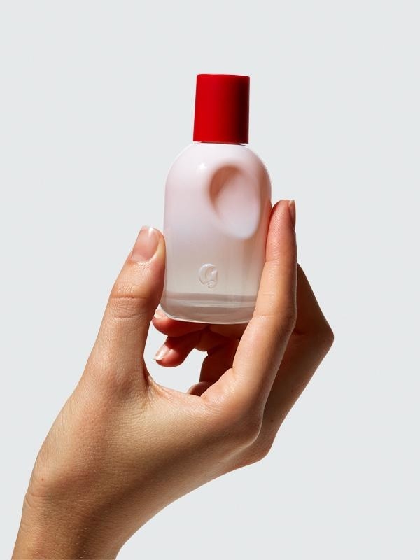 Pink and red Glossier You perfume bottle