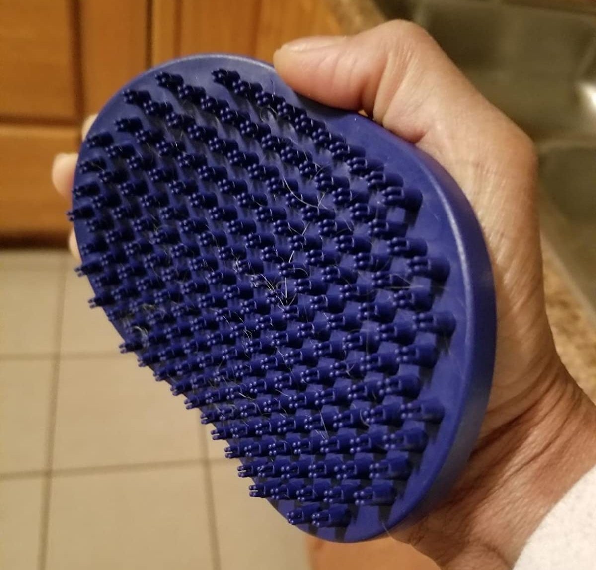 The brush, secured to someone's hand