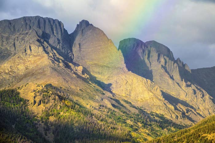 Rainbow over jagged grey mountains