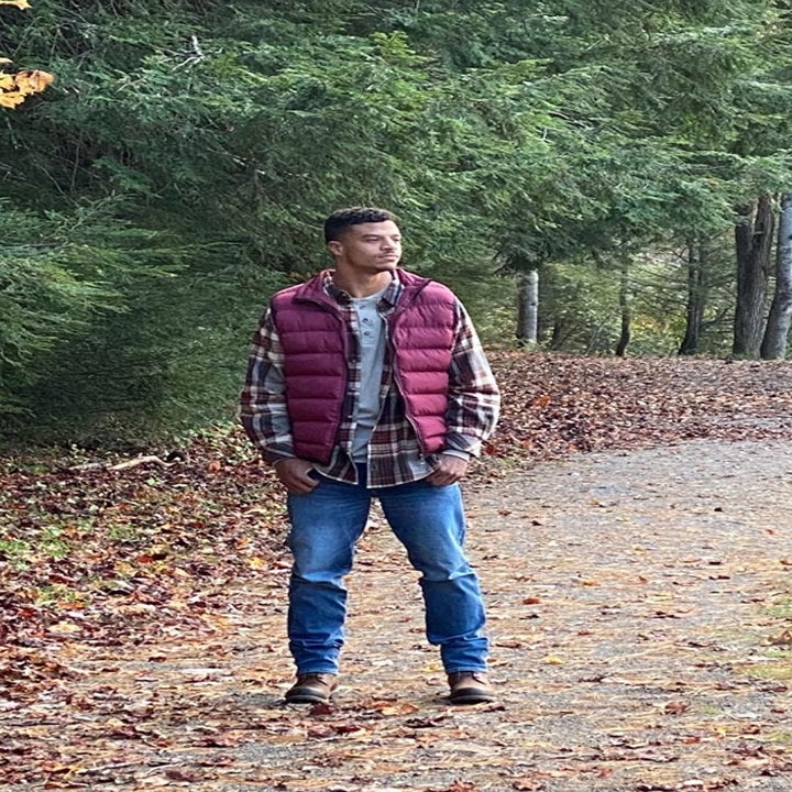 A different reviewer wearing the plaid shirt in red