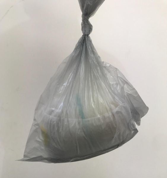 Reviewer&#x27;s picture of the bag holding a large diaper 