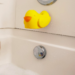 Yellow silicone duck covering bath faucet with open beak covering drain plug