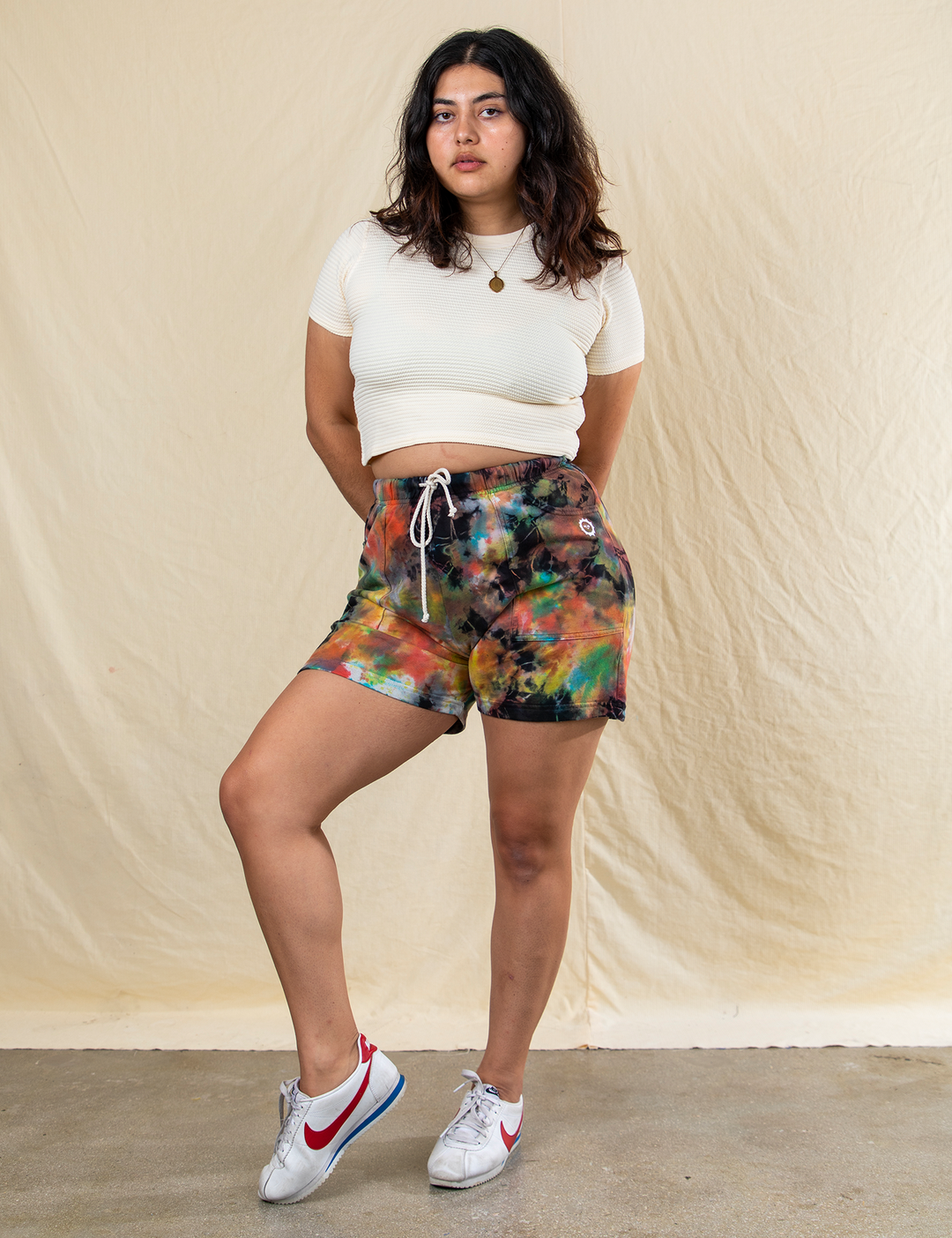 Model wearing the mid-thigh length shorts with an elastic waistband and pockets
