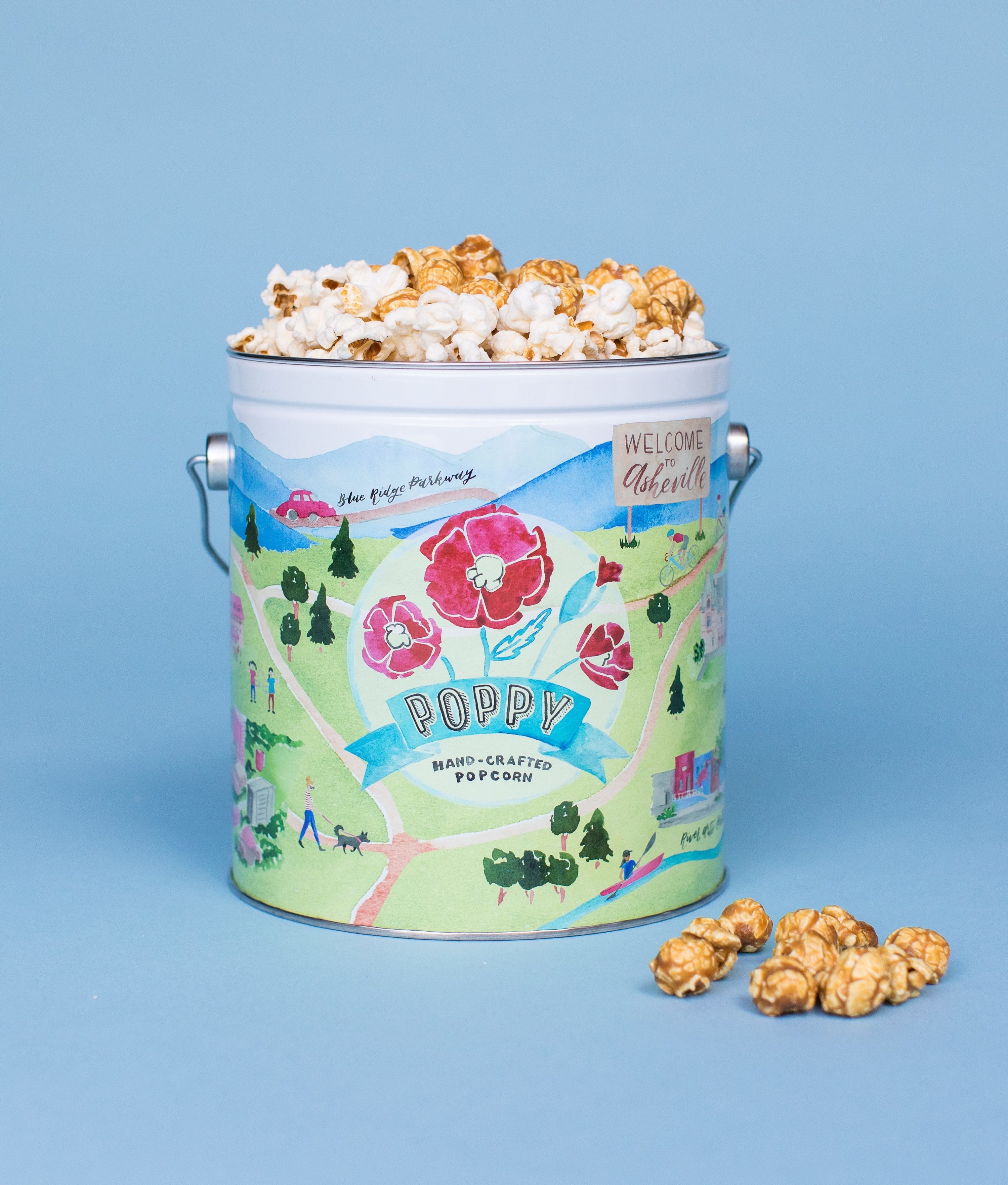 the popcorn tin with an illustrated tin holding the popcorn