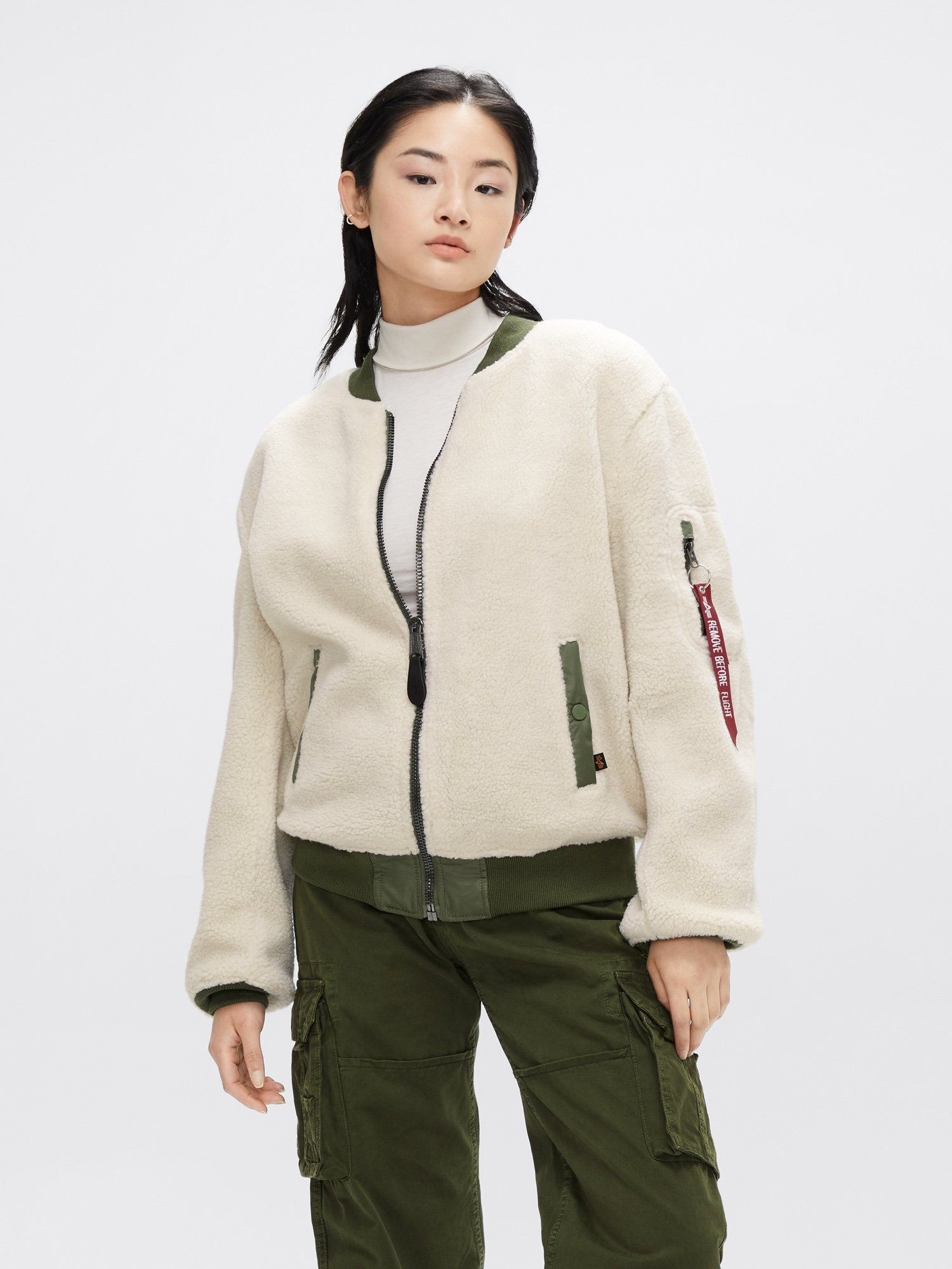 A model wearing the sherpa bomber in light cream