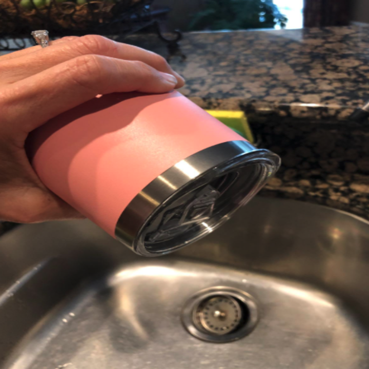 reviewer photo showing the tumbler does not leak by tipping it over kitchen sink 