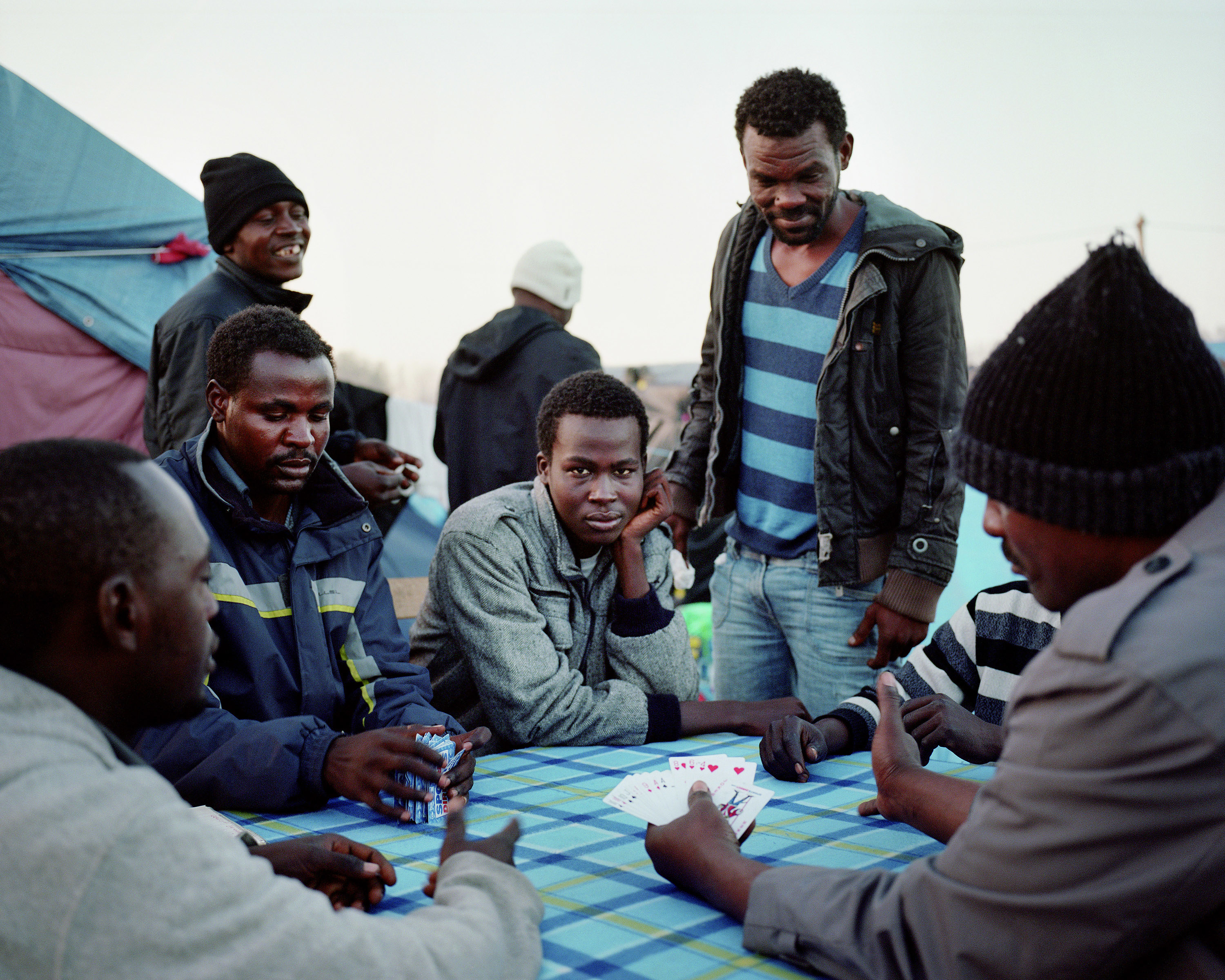 Men playing cards outside