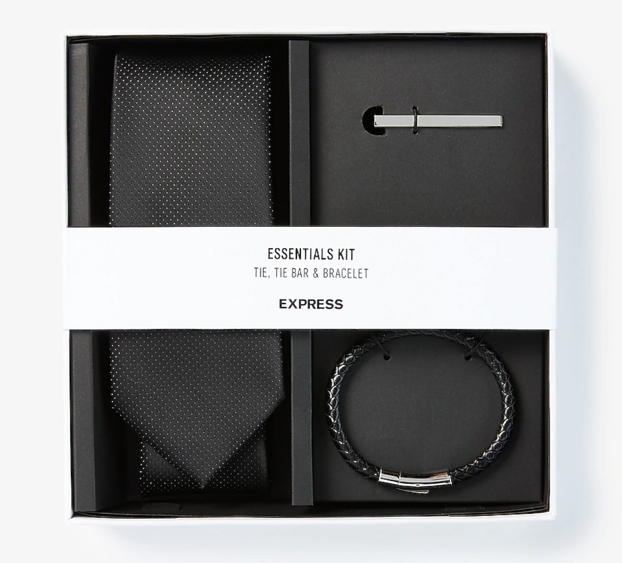 A box with a black tie, silver tie clip and black bracelet inside 