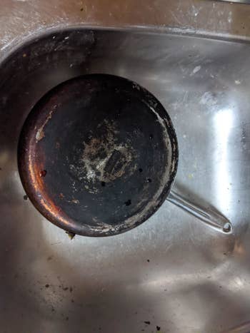 a stainless steel pot with a burnt bottom