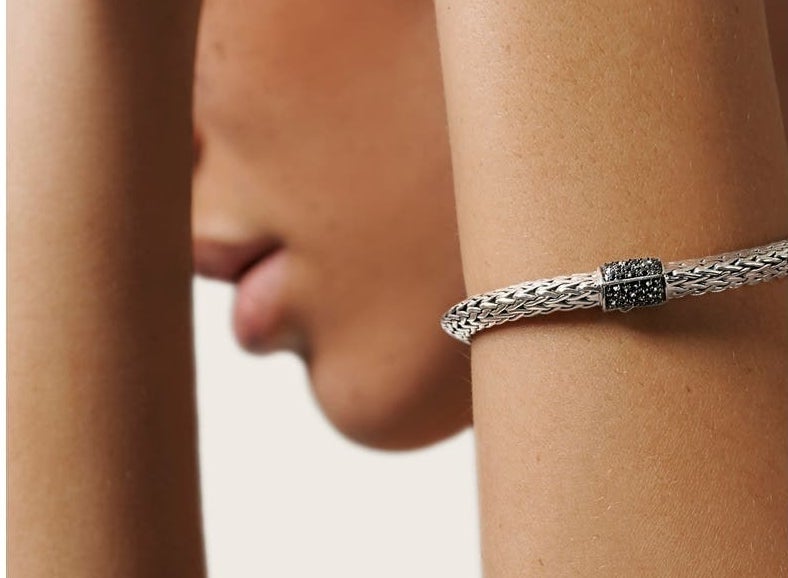 Model wearing the sterling silver braided necklace with black sapphire clasp