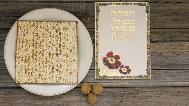Matzah on a plate next to some Jewish literature