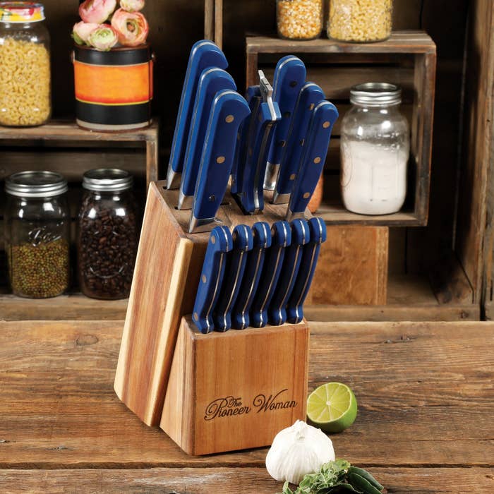 the set of knives in blue displayed in a wooden box with the pioneer woman engraved on it