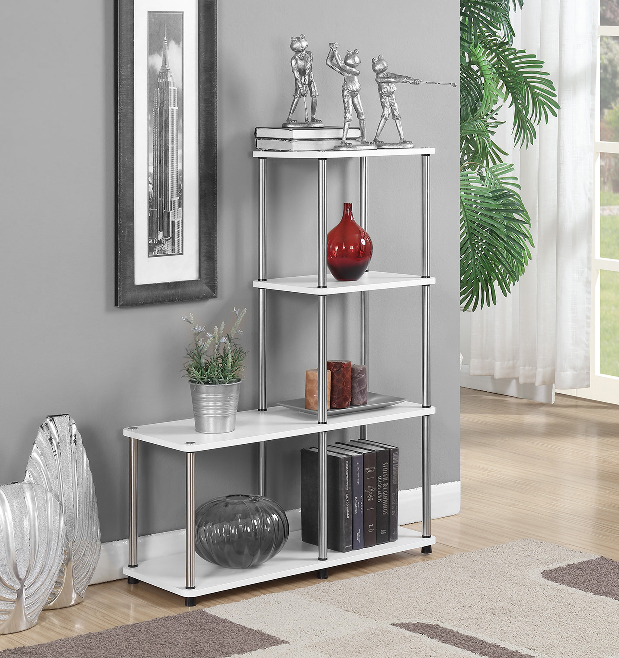 the bookshelf with metal poles and white shelves