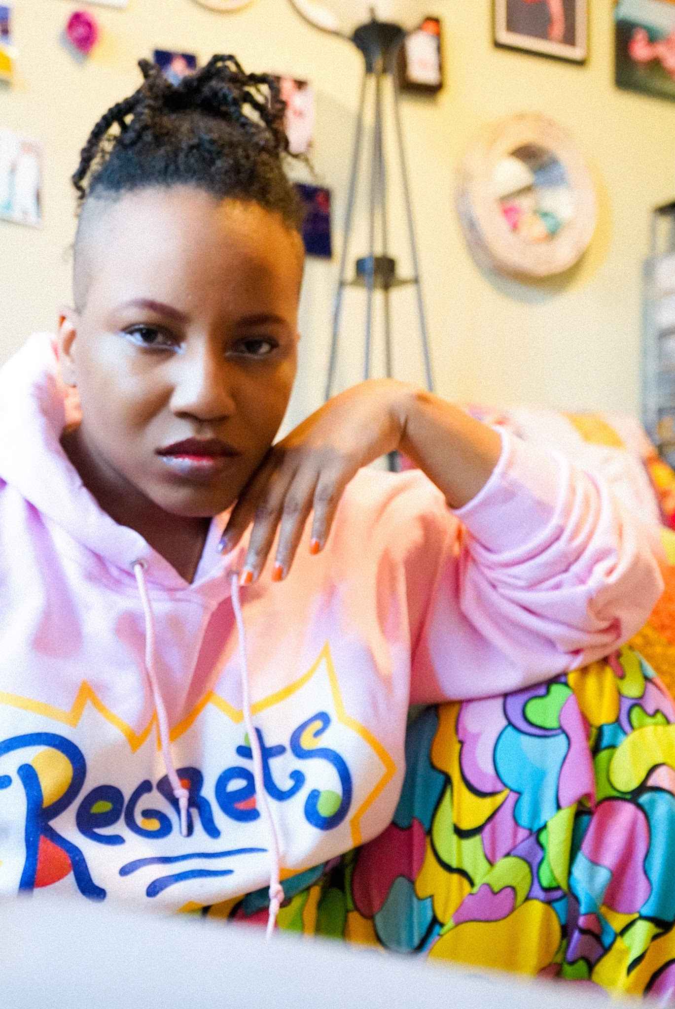 BuzzFeed writer wearing the regrets hoodie in pink