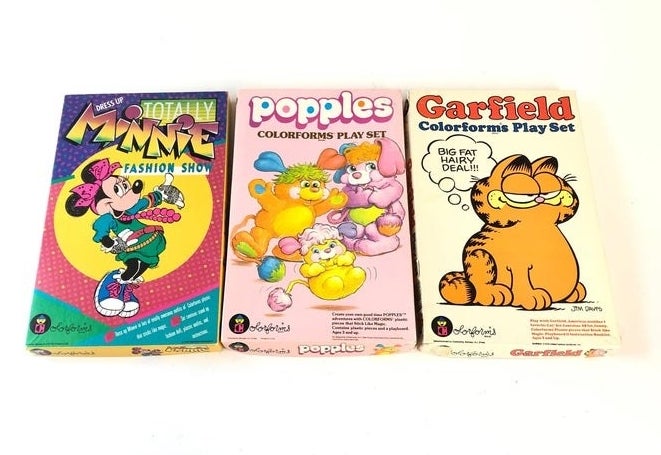 A Minnie Fashion Show, Popples, and Garfield Colorforms play set