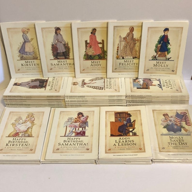 A set of dozen different American Girl doll books