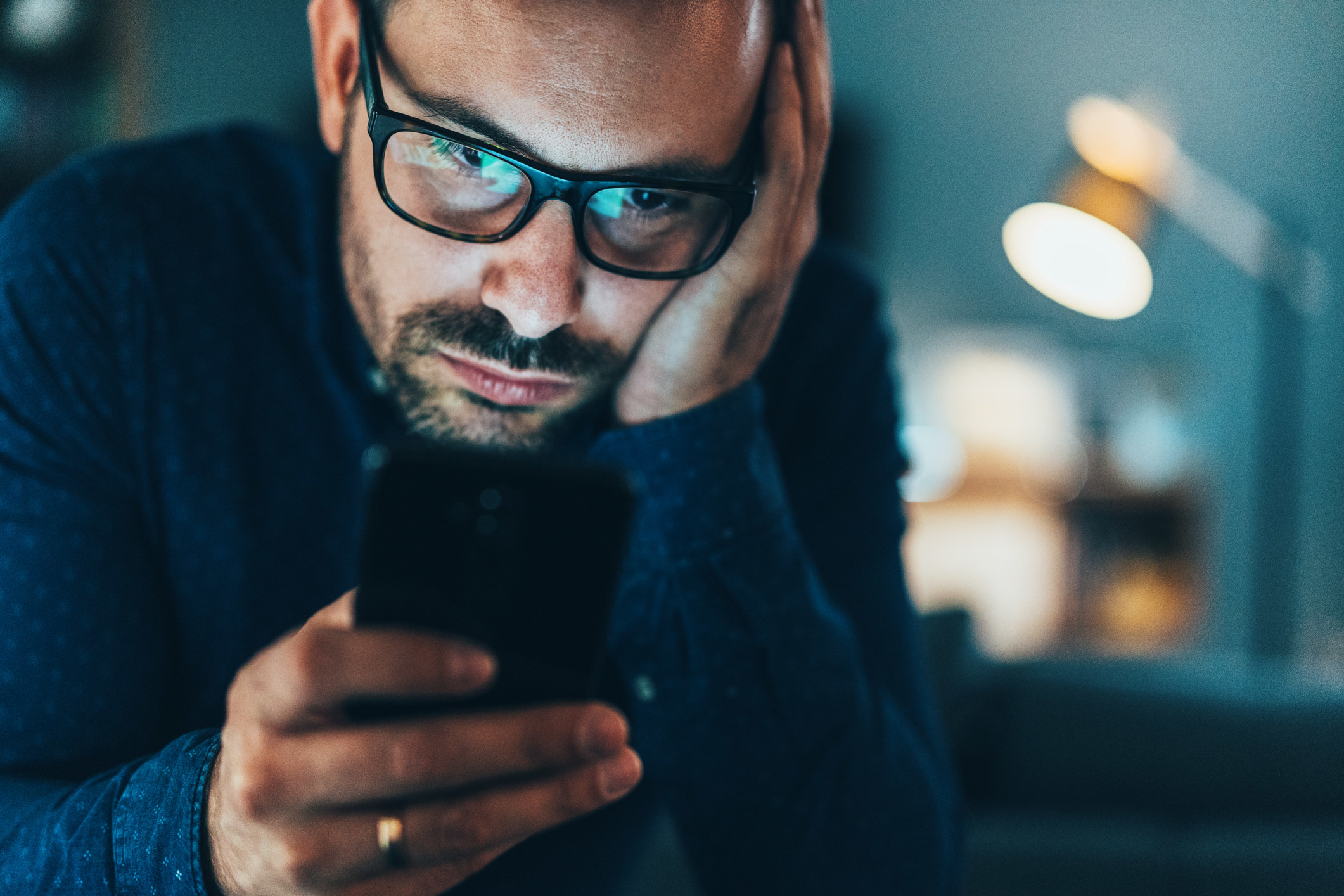 a man staring down at his phone