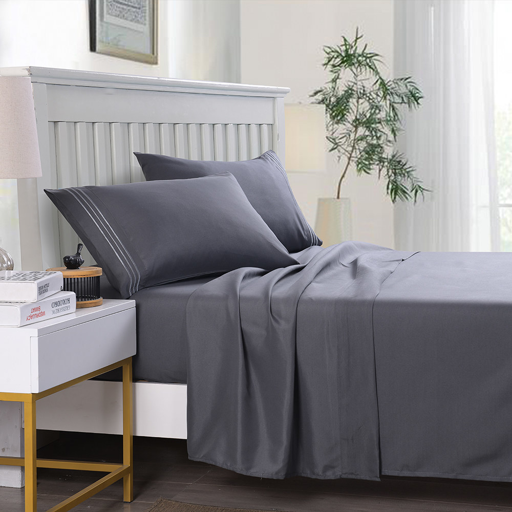 the sheet set in gray on a bed