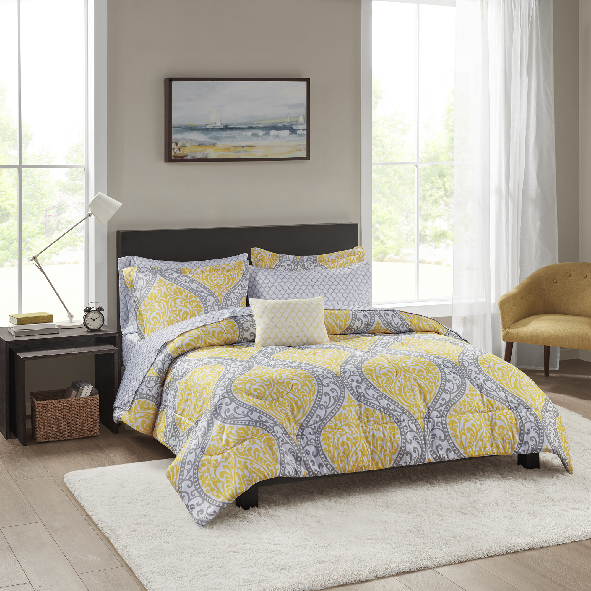 yellow and gray bedding set on a bed in a bedroom