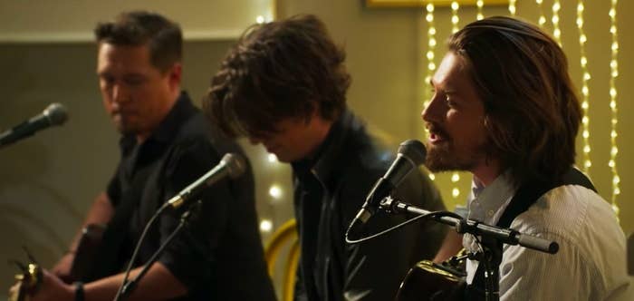 Hanson perform sitting in front of microphones