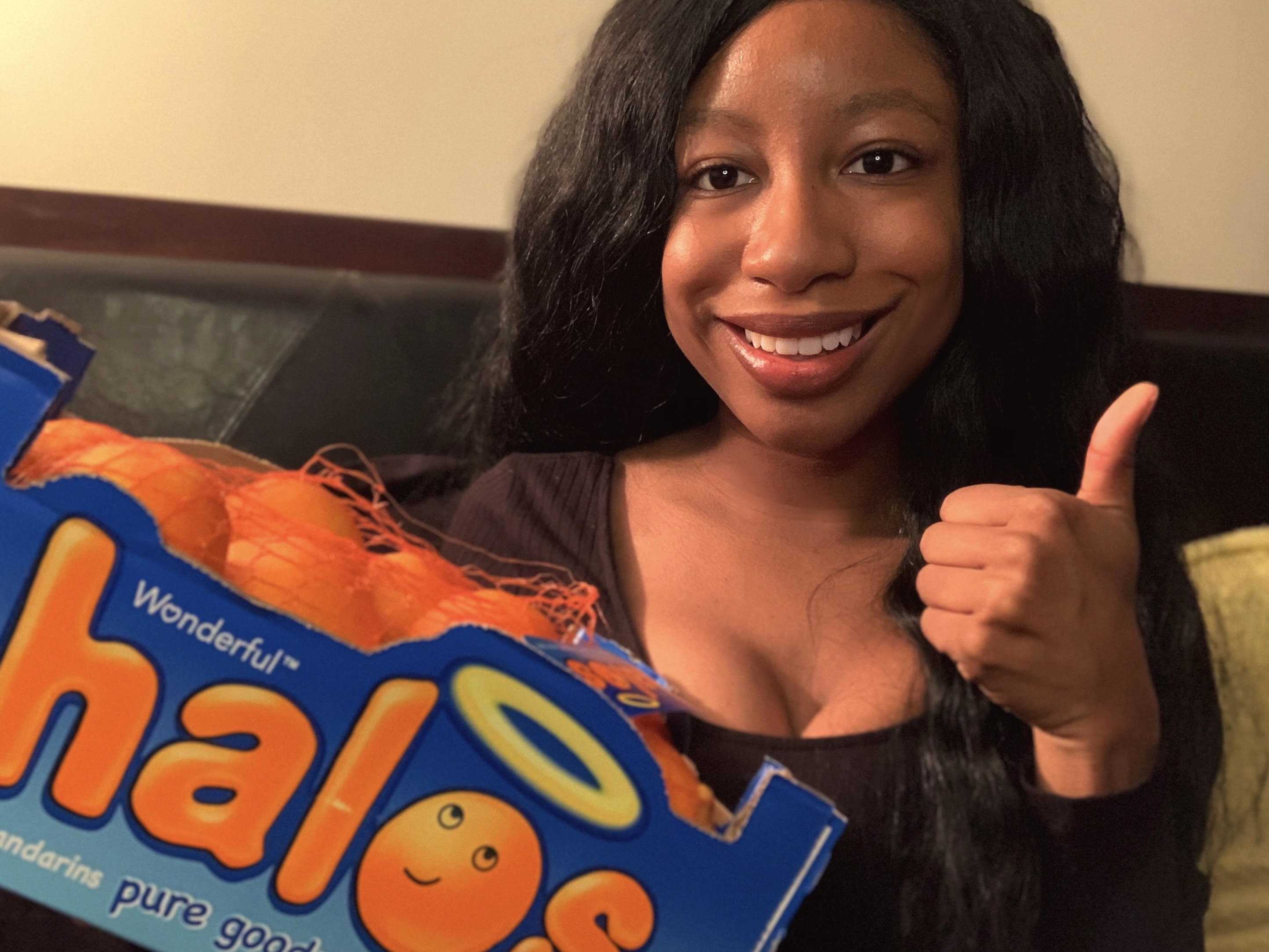 An image of the author holding a bag of clementines. 