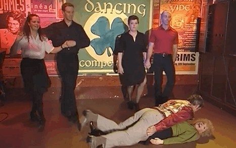 Kath and Kel &quot;dance&quot; lying on the floor while four other people dance while standing behind them