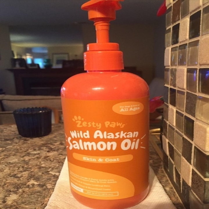 an orange bottle of wild Alaskan salmon oil on a counter