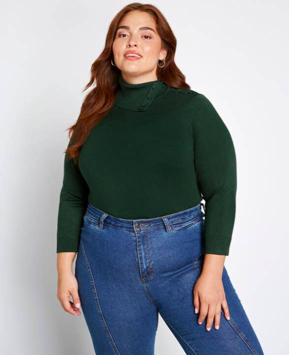 a model wearing the turtleneck in hunter green