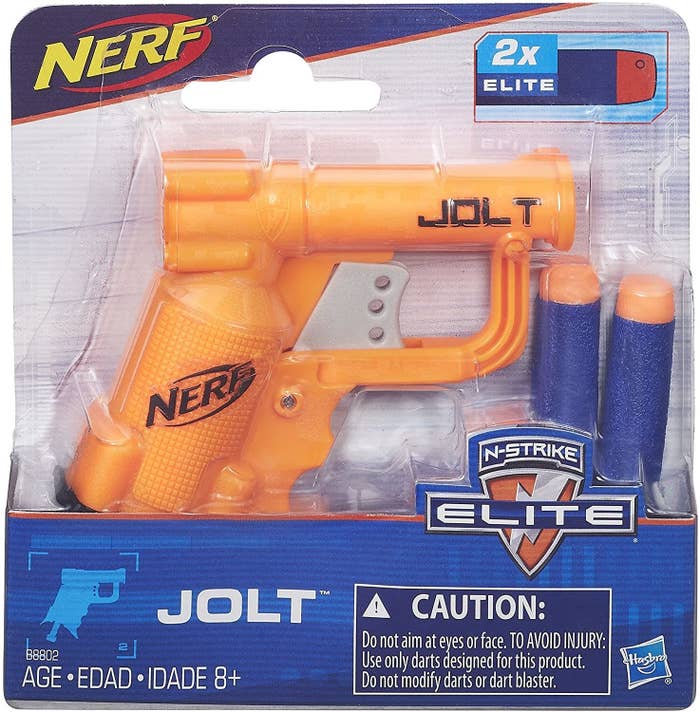 A Nerf gun with two Styrofoam pellets in a package