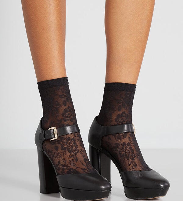 The socks in black layered under some block heels 