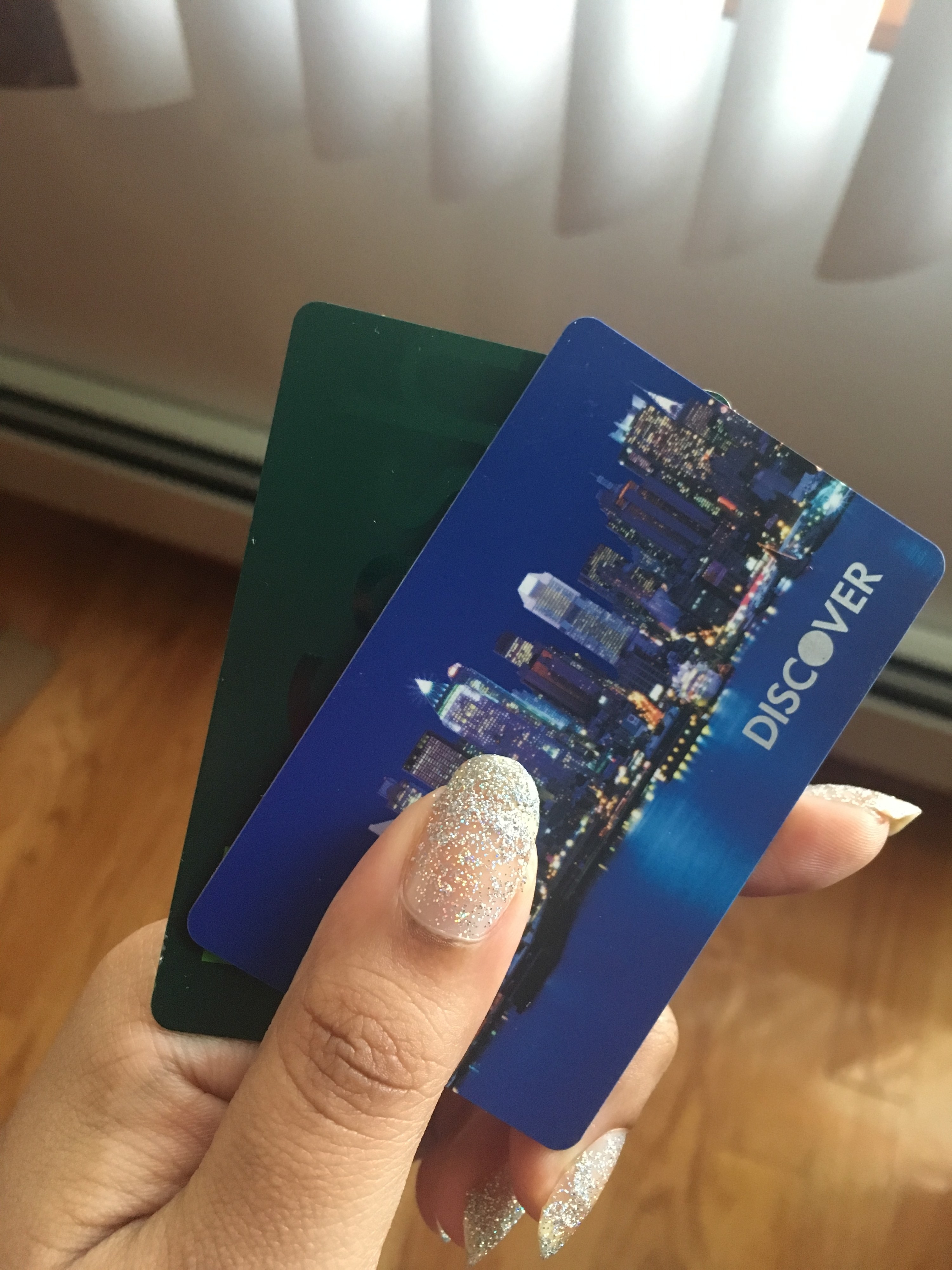 a hand holding credit cards