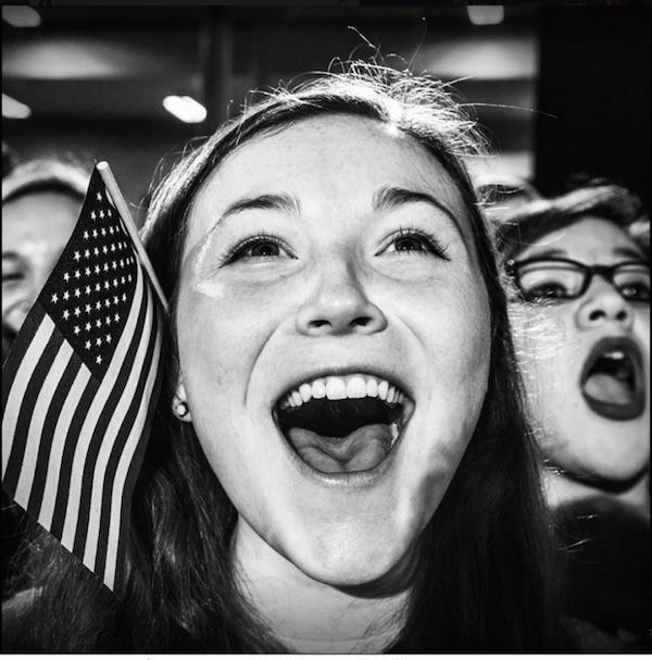 Young girl with American flag screaming in joy