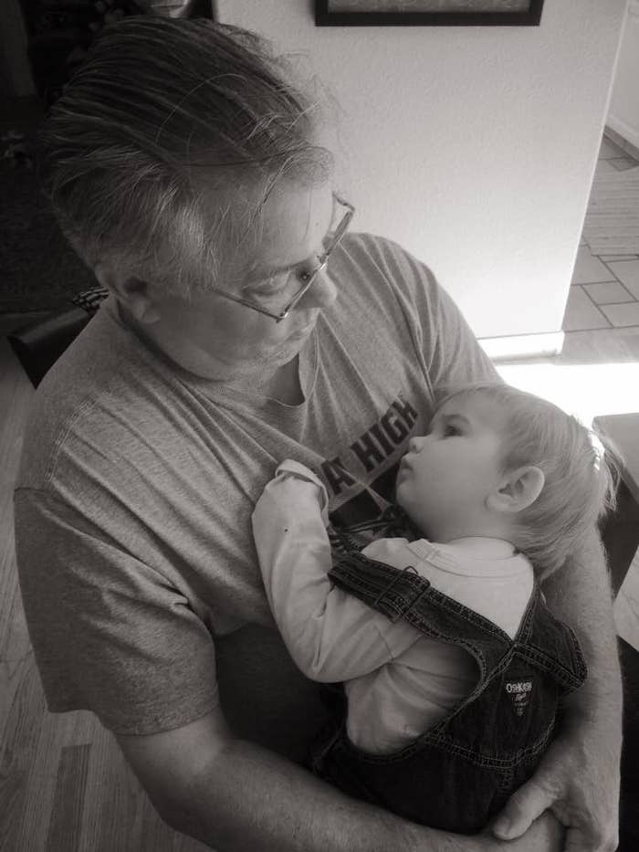 George Finefrock gazes down at his infant grandson, who is cradled in his arms