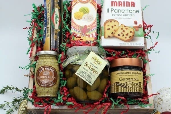 box filled with items like olives, panettone, and more