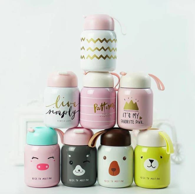 A stack of eight cute mini thermos&#x27;, each with a different design